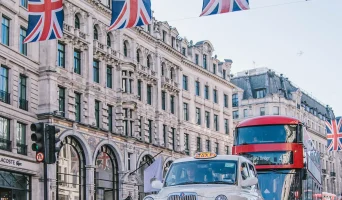 international bootcamp in London city with bus and flags